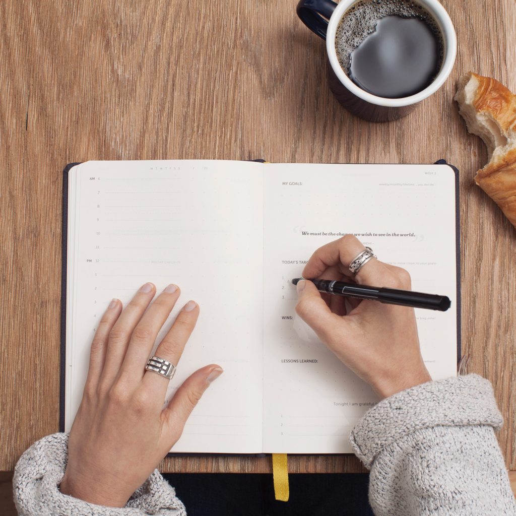 woman with coffee and planner